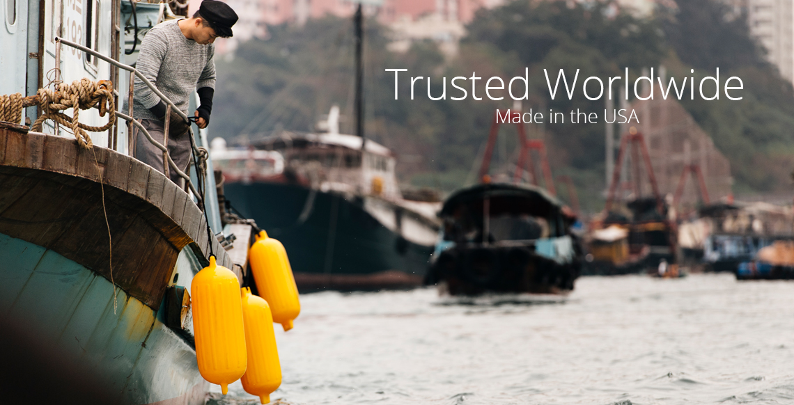 Yellow boat fenders hung along a boat, Polyform G Series