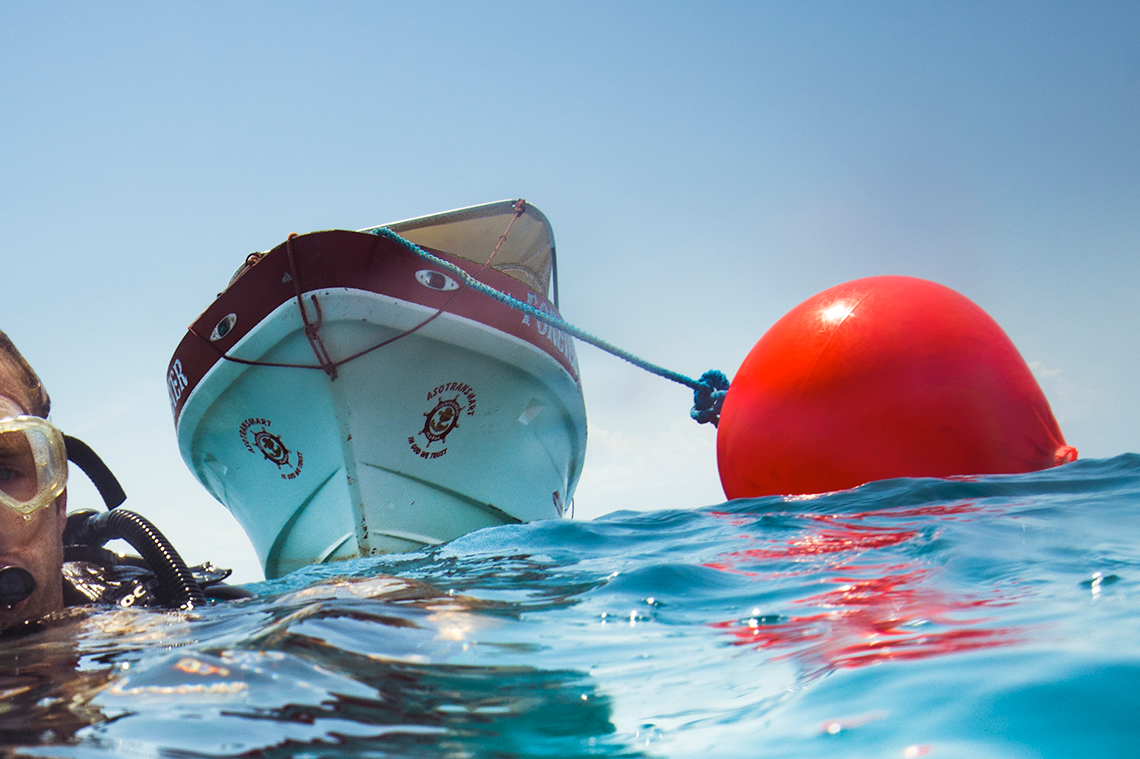 Catamaran picking up a buoy with a mooring ball hook, Polyform CC Buoy Red