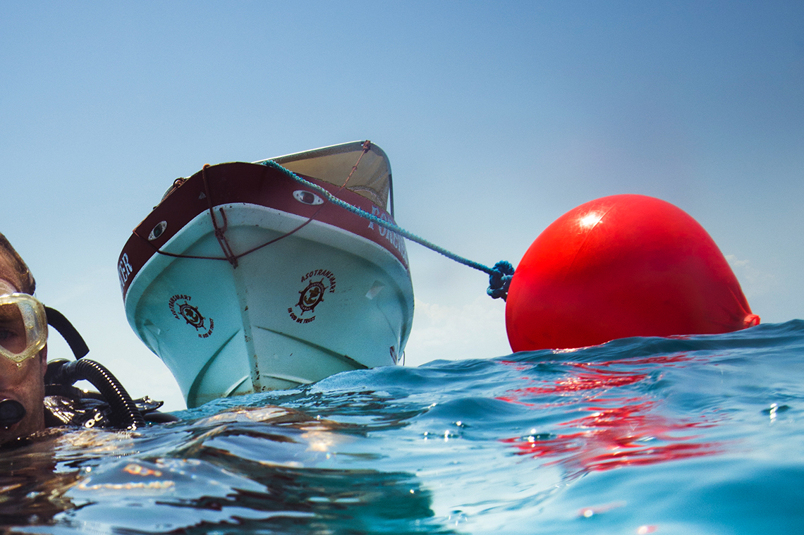Catamaran picking up a buoy with a mooring ball hook, Polyform CC Buoy Red